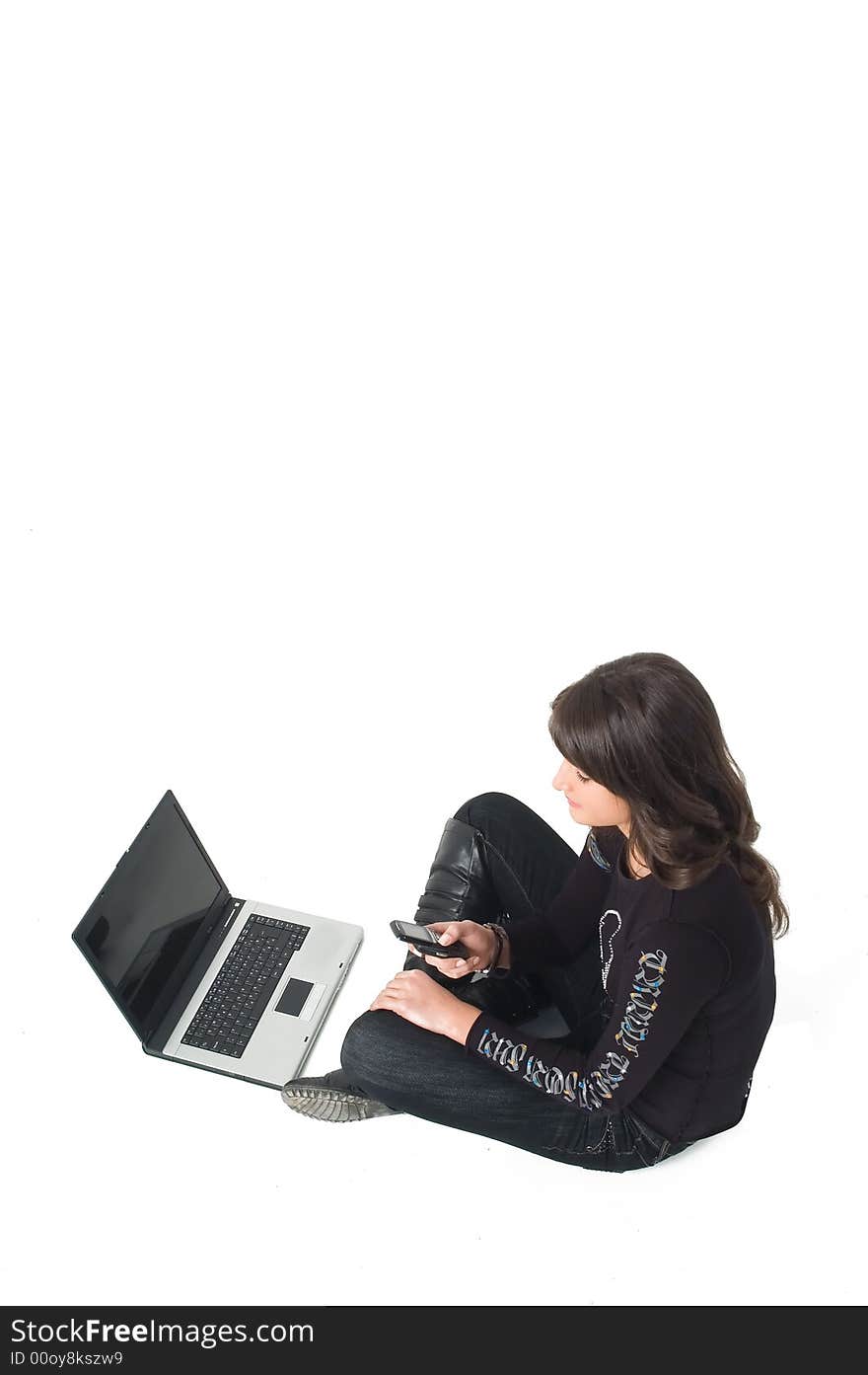 Young brunette girl in black with lap top computer representing modern communications. Young brunette girl in black with lap top computer representing modern communications.