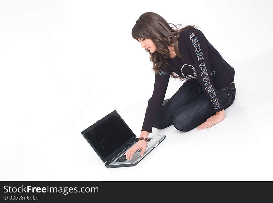 Young brunette girl in black with lap top computer representing modern communications. Young brunette girl in black with lap top computer representing modern communications.