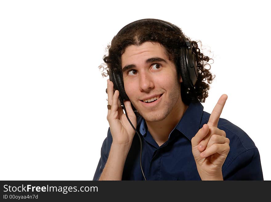 Young man listening to headphones, isolated on white. Young man listening to headphones, isolated on white