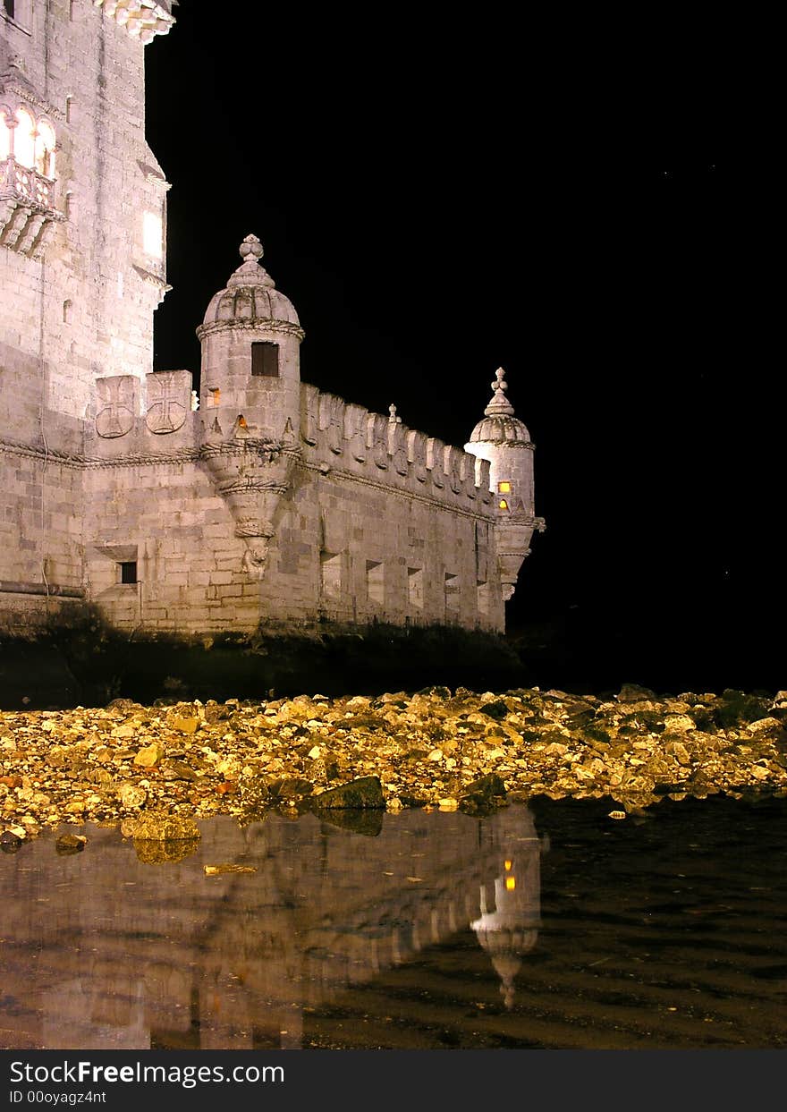 Detail from belem tower and reflection in water by night