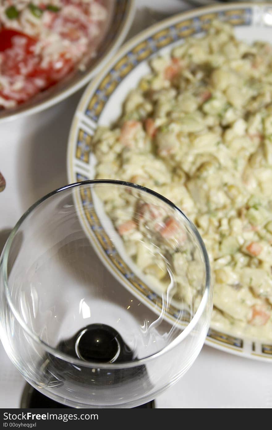 Close-up of served table with salads, plates and glasses. Close-up of served table with salads, plates and glasses