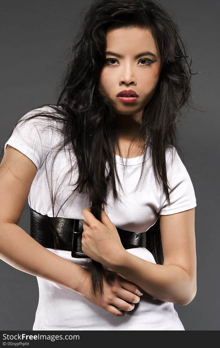 Oriental model posing on grey background