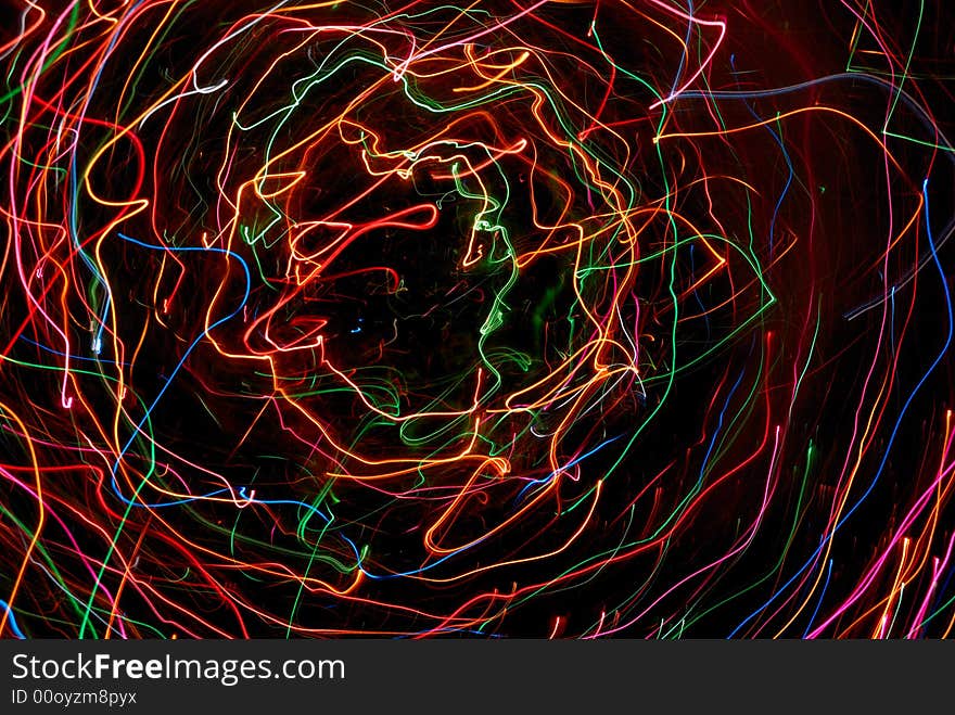 Multicolor abstract light tracks against black background