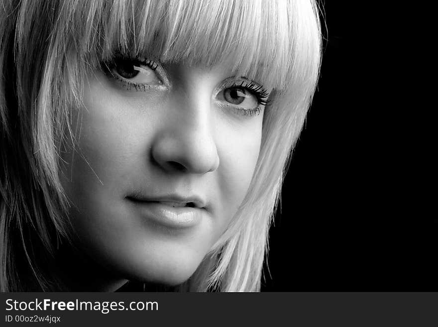 Studio portrait of a beatiful blond girl on black background. Studio portrait of a beatiful blond girl on black background