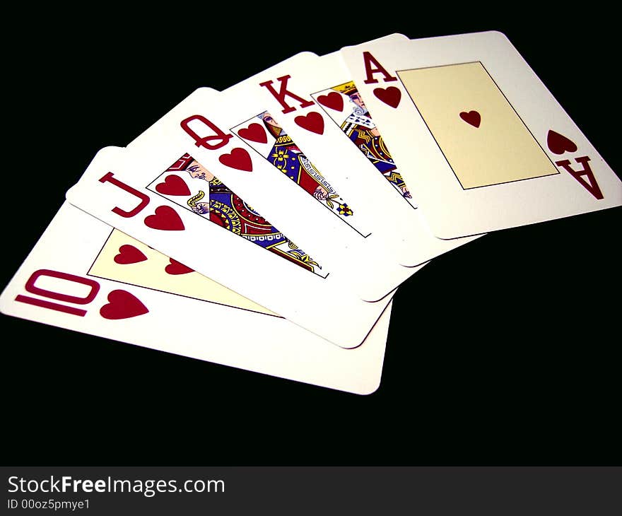 An image with a close detail of a royal flush on black background