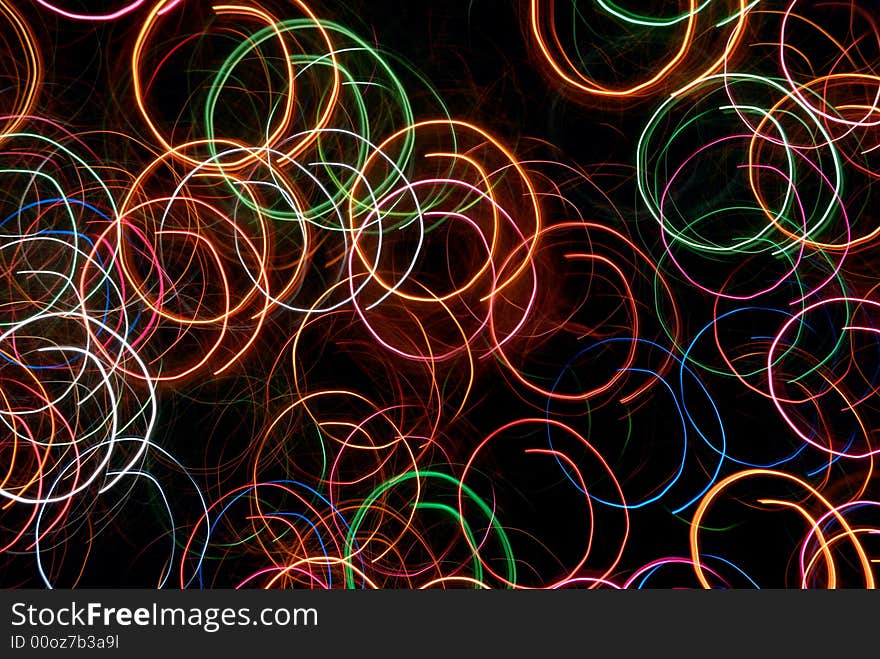 Multicolor circular abstract light tracks against black background. Multicolor circular abstract light tracks against black background