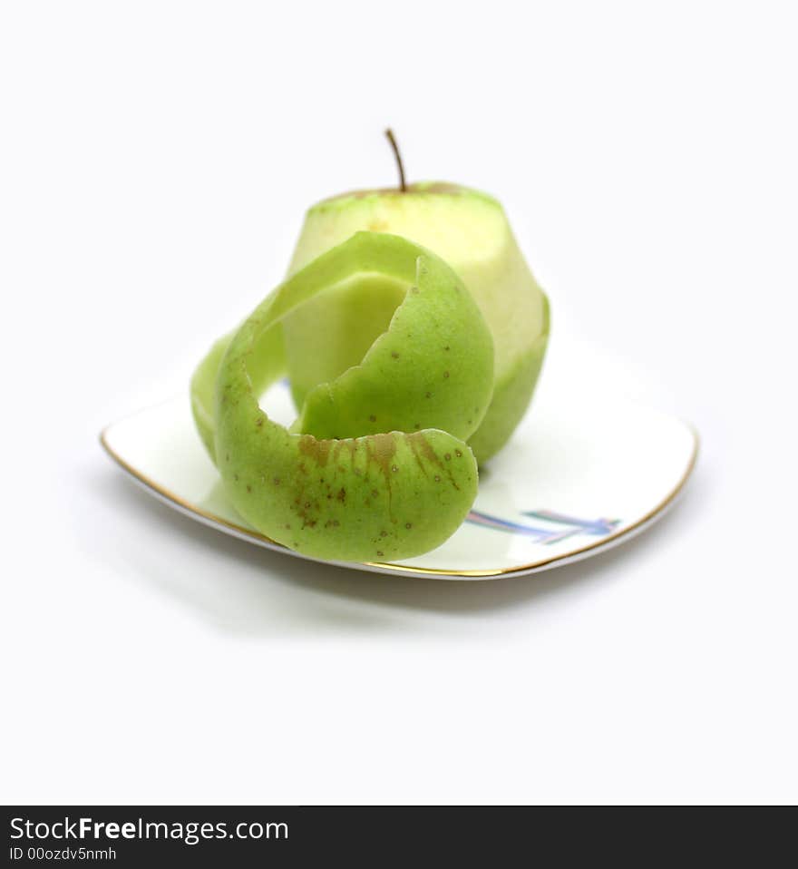 Fresh green apple on white plate on white background