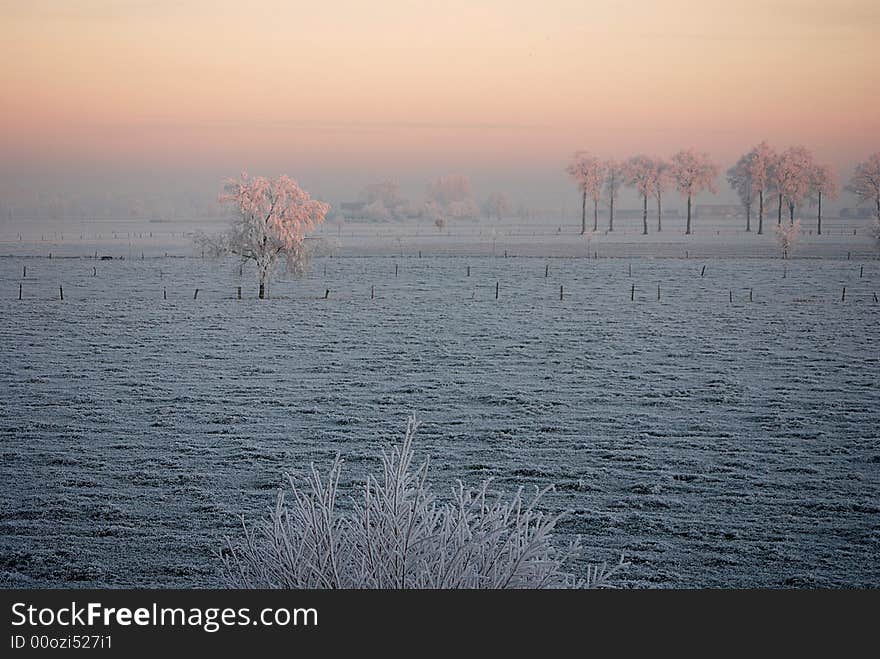 Sunrise over a winter landscape in the north of Belgium (region Antwerp)