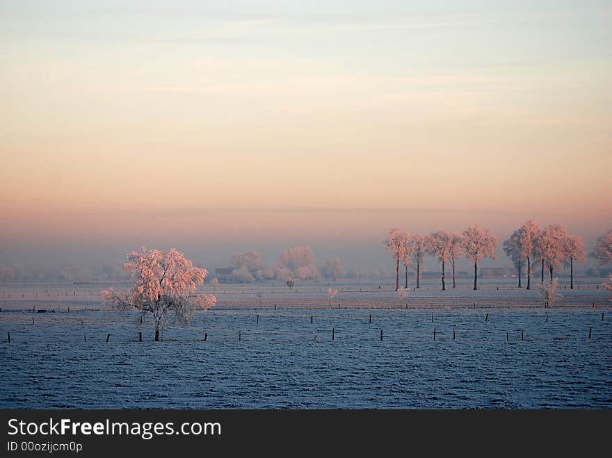 Sunrise over a winter landscape in the north of Belgium (region Antwerp)