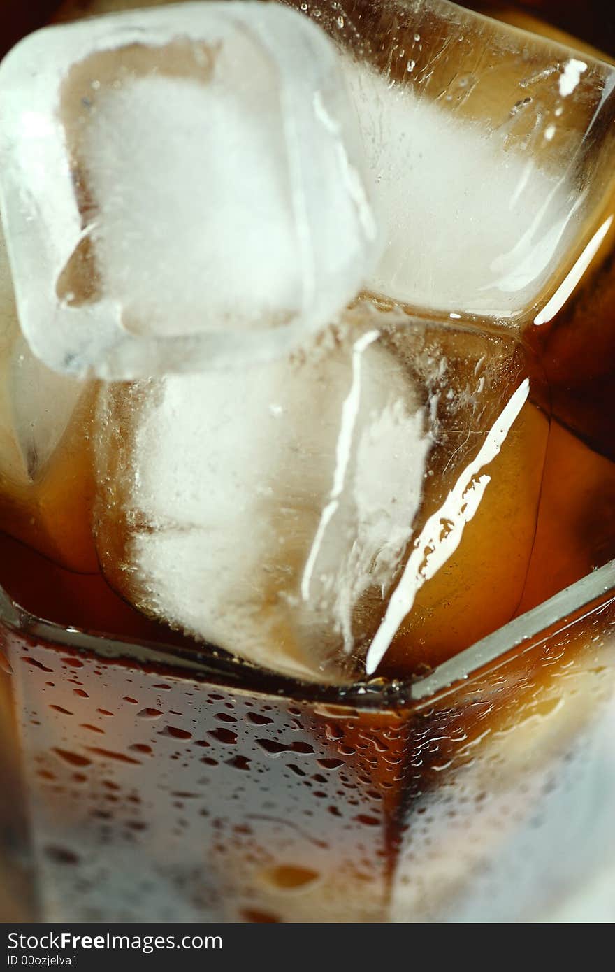 Ice cubes soaked in cold whisky drink