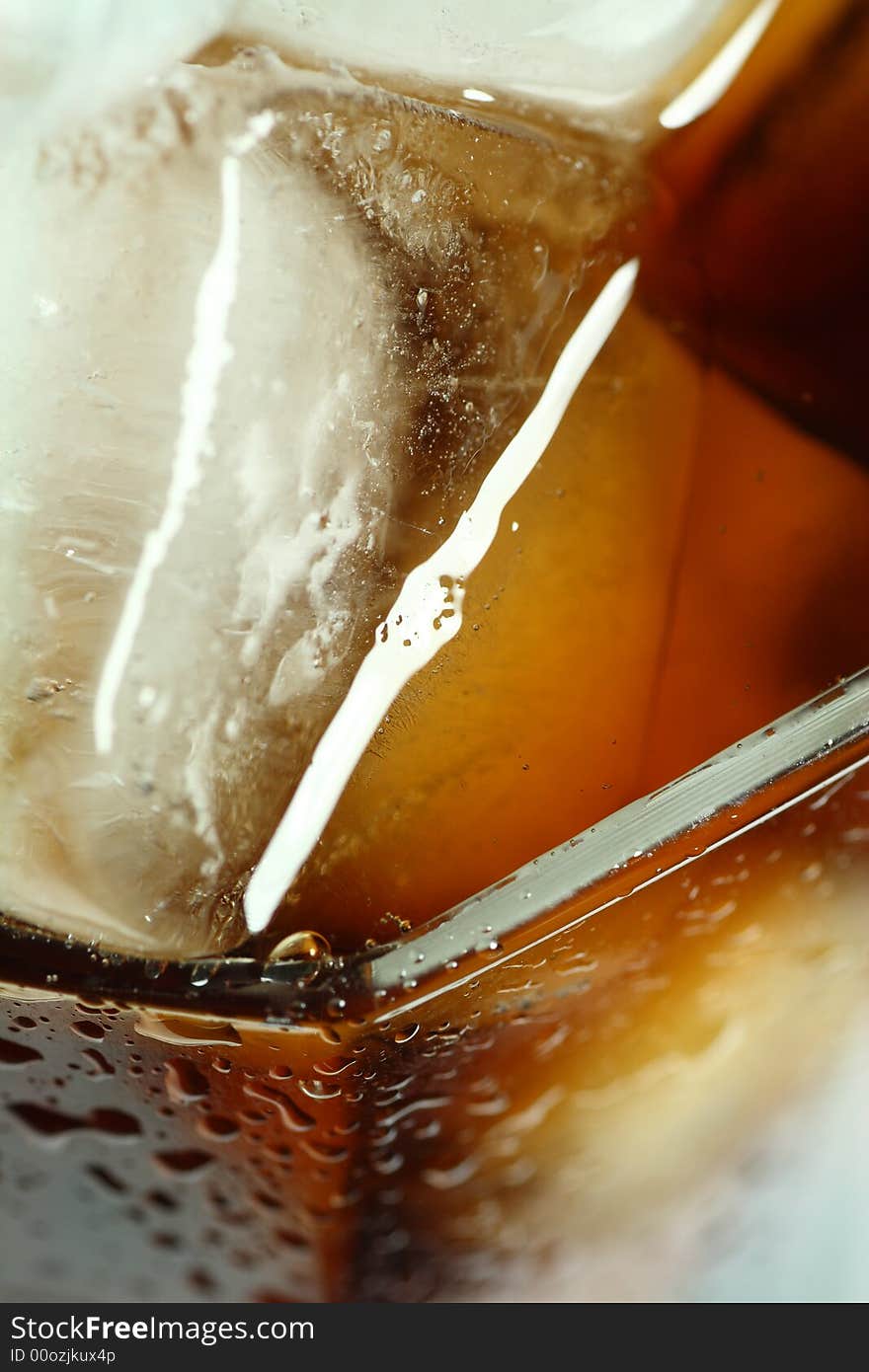 Ice cubes soaked in cold whisky drink