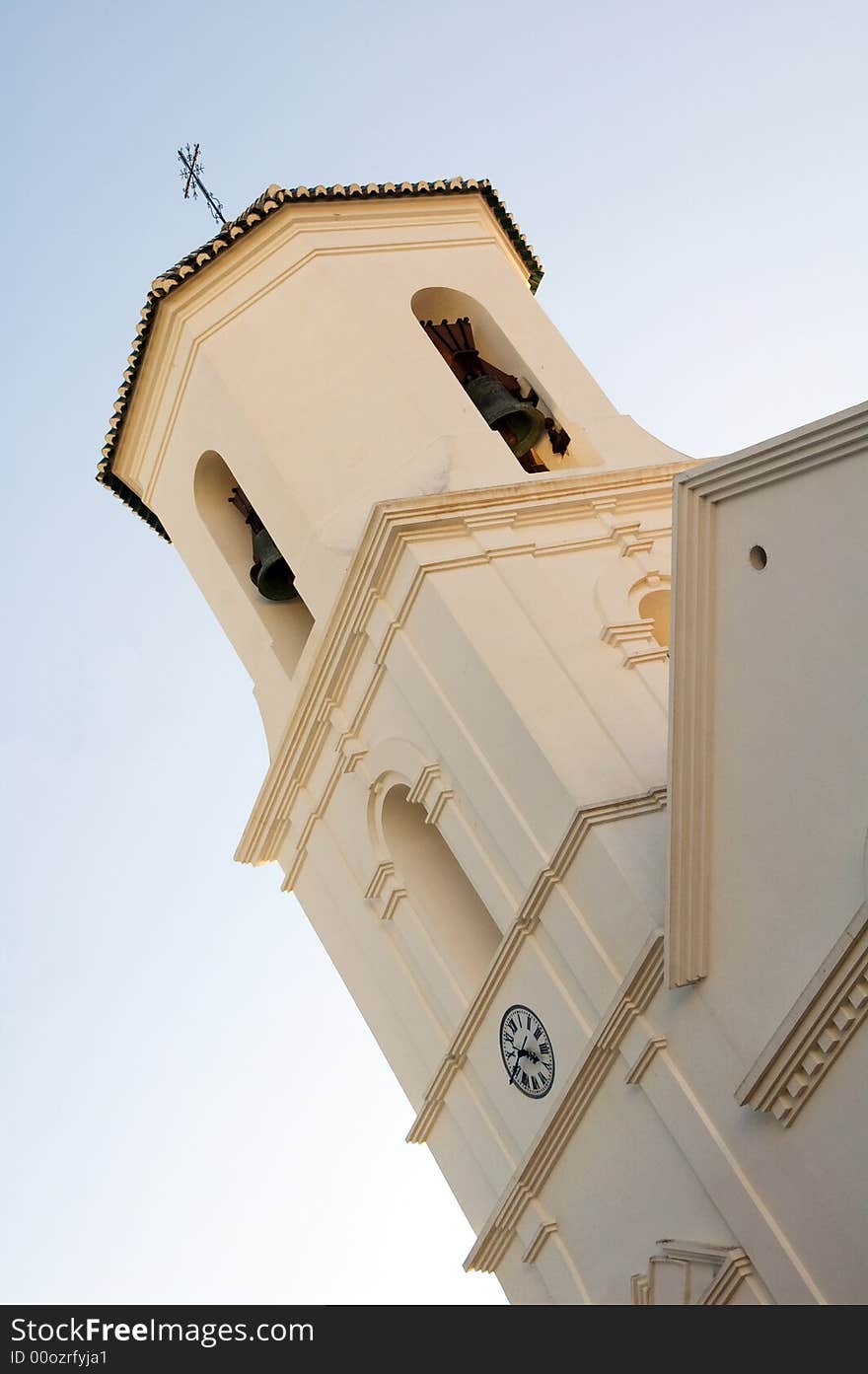 Church bell tower with clock in small city Nerja near Malaga