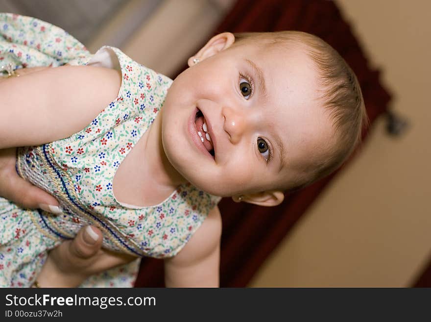 Baby girl being held in the air by her mother. Baby girl being held in the air by her mother.