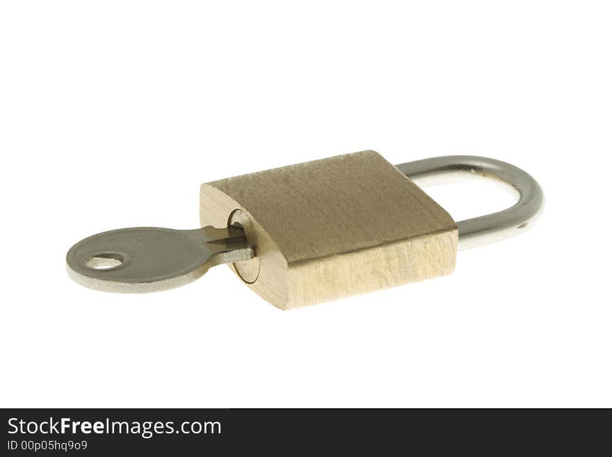 Isolated closed brass padlock with key inside