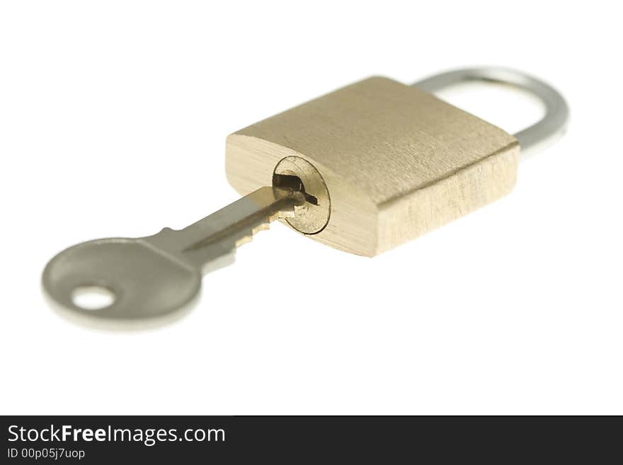 Isolated Closed Brass Padlock With Key About To Op