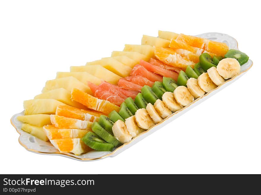 Fruit salad made of banana, kiwi, orange, grapefruit and pineapple isolated on white