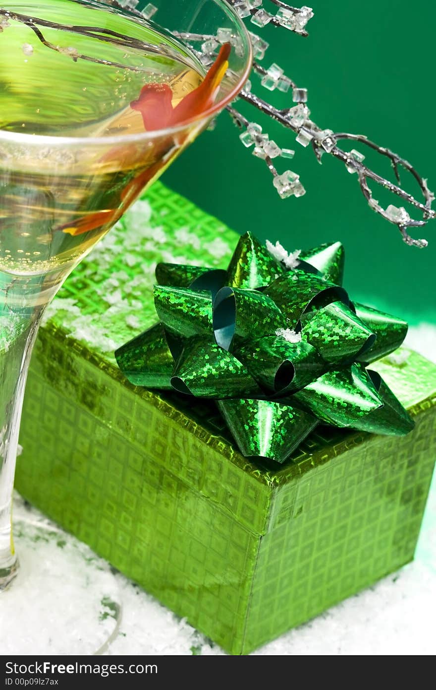 Glass with champagne and gift box