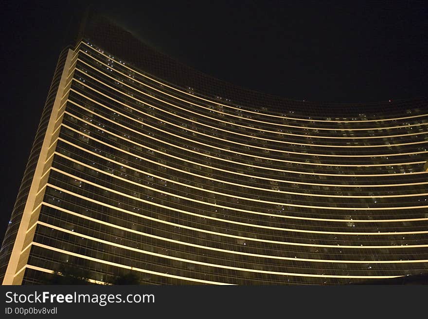 A curved black and white hotel shot at night. A curved black and white hotel shot at night