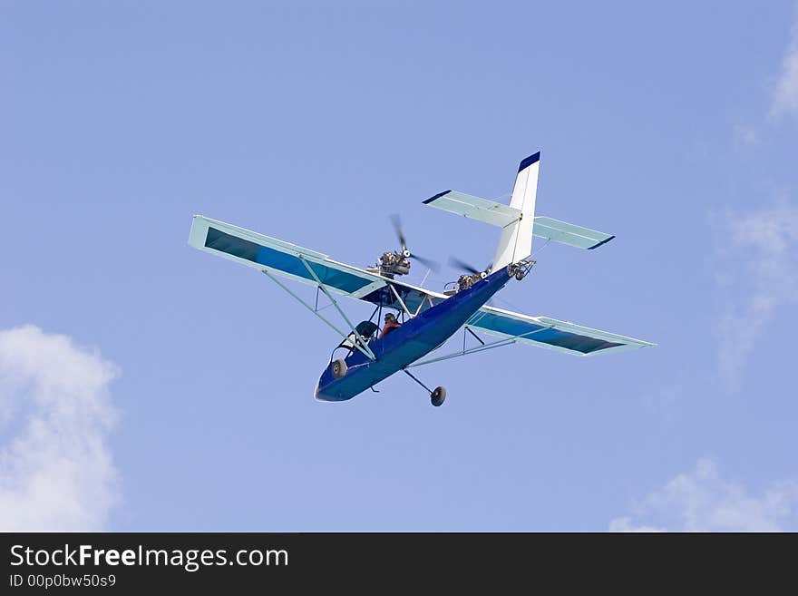 A small rear prop plane flying against the sky