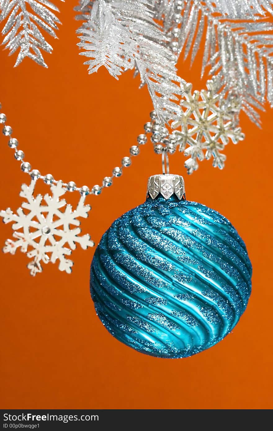 Blue festive decoration on silver Christmas tree