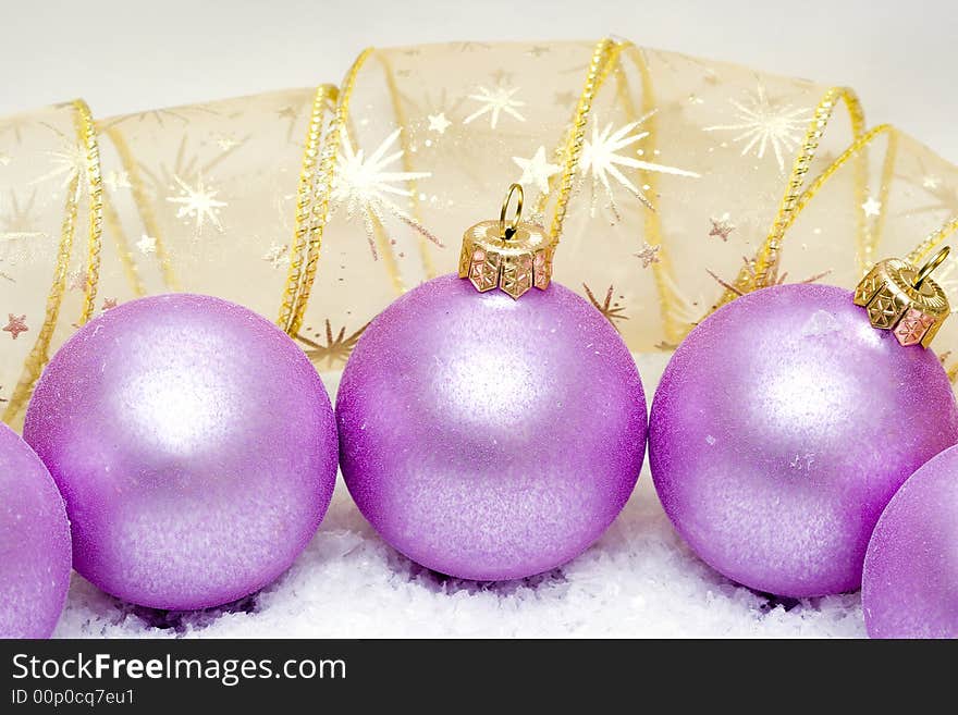 Pink Christmas balls in snow