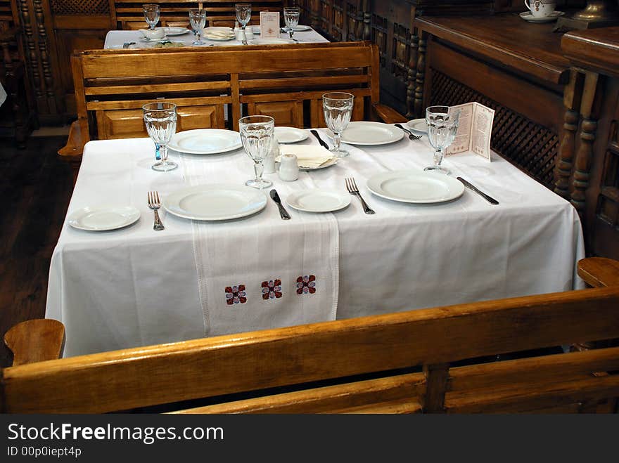 The Inlaid tree interior restaurant. The Table with white tablecloth and instrument. The Inlaid tree interior restaurant. The Table with white tablecloth and instrument.