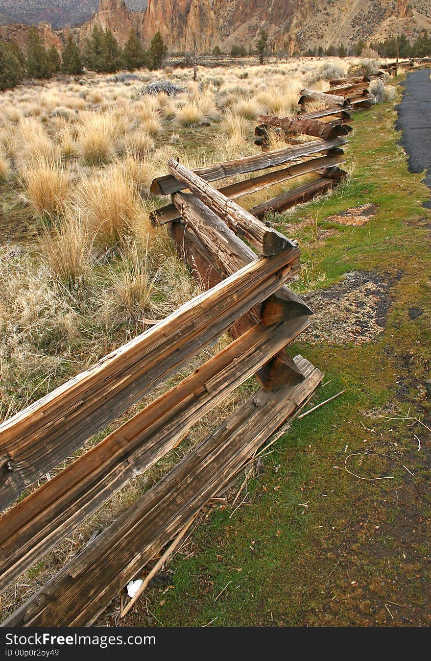 Crooked log fence extending into the distance