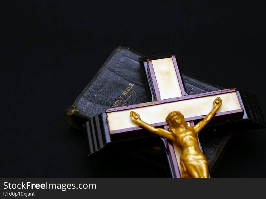 Striking full color image of an old crucifix laying on top of an ancient leatherbound bible. Striking full color image of an old crucifix laying on top of an ancient leatherbound bible