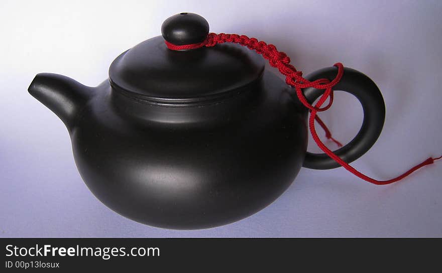 It is Chinese teapot with red wire.