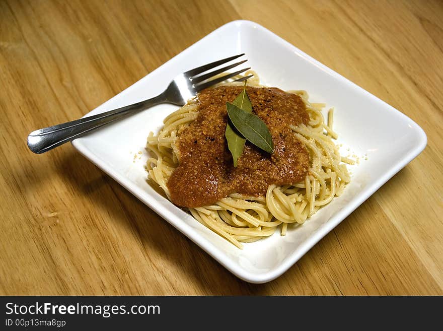 Plate of pasta and sauce on white plate. Plate of pasta and sauce on white plate.