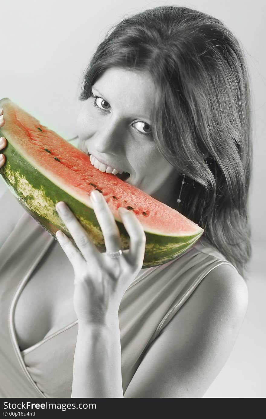 A woman eating a watermelon. A woman eating a watermelon