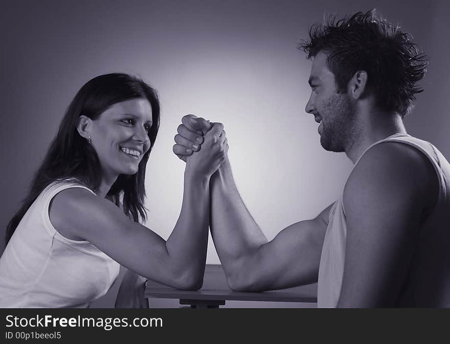 A pair plays game arm wrestling.