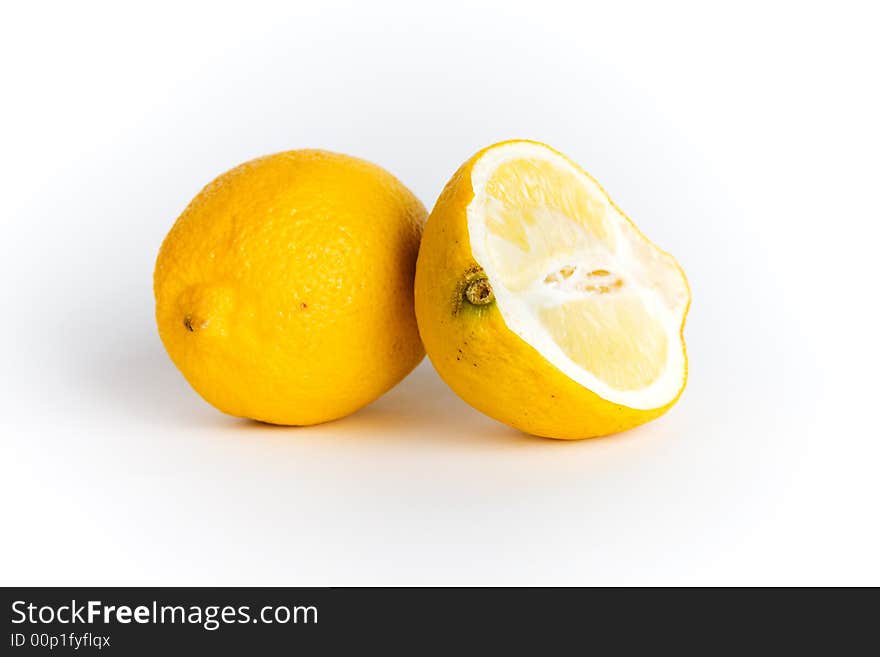 A lemon and a half isolated on white background