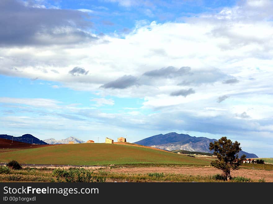 Cloudy autumnal sky and country. Beautiful autumn country landscape. cultivated land, hills, blue sky & clouds. Sicily, Italy