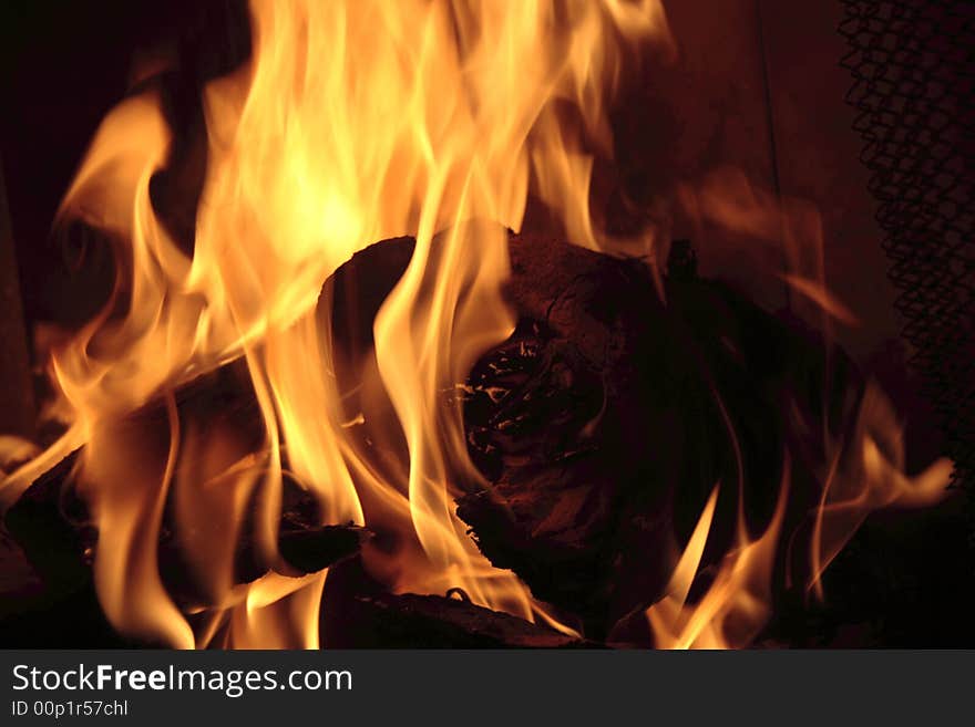 Burning logs in a fireplace.