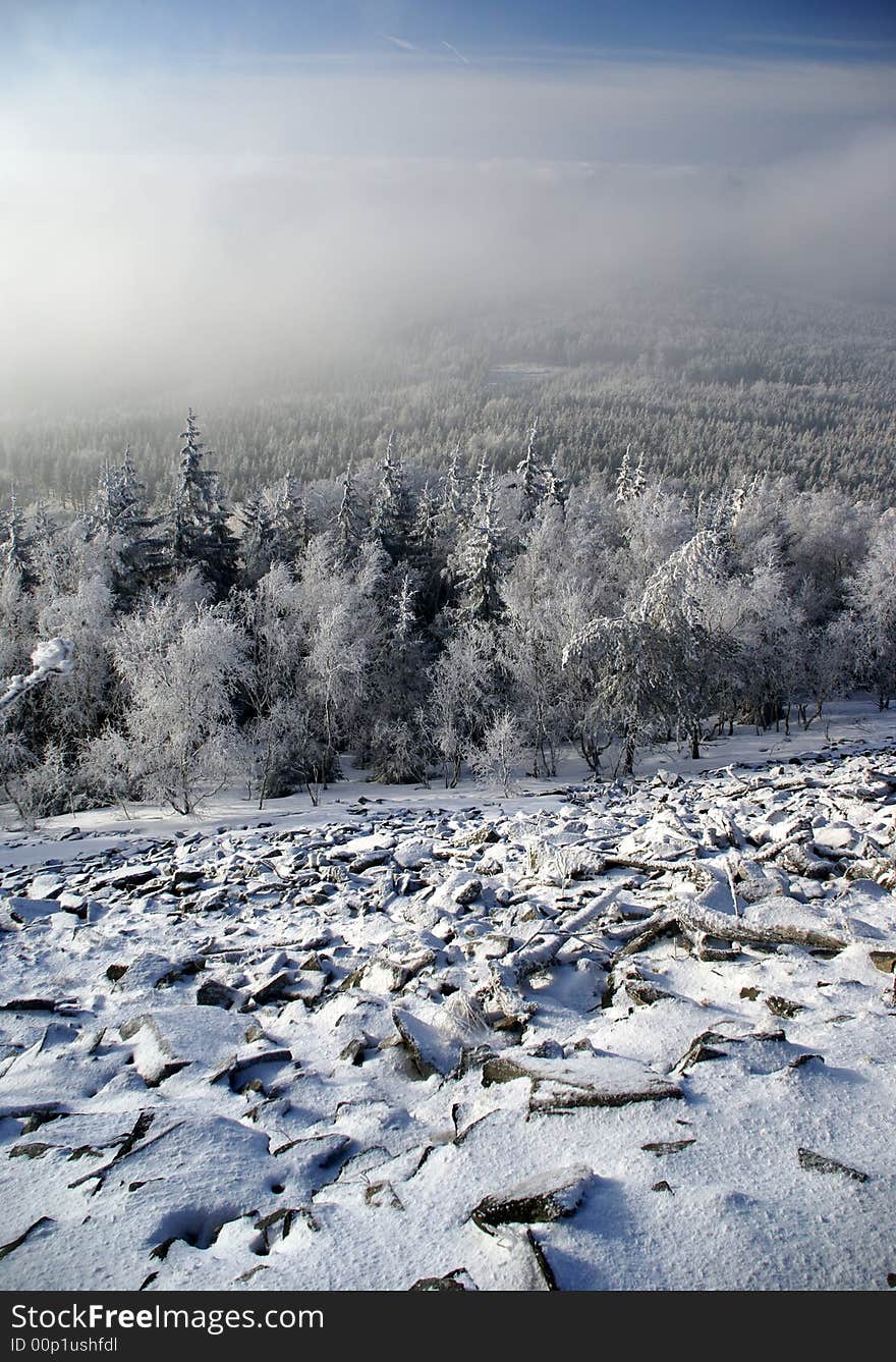 View of snow covered valley with stone field in foreground. View of snow covered valley with stone field in foreground.