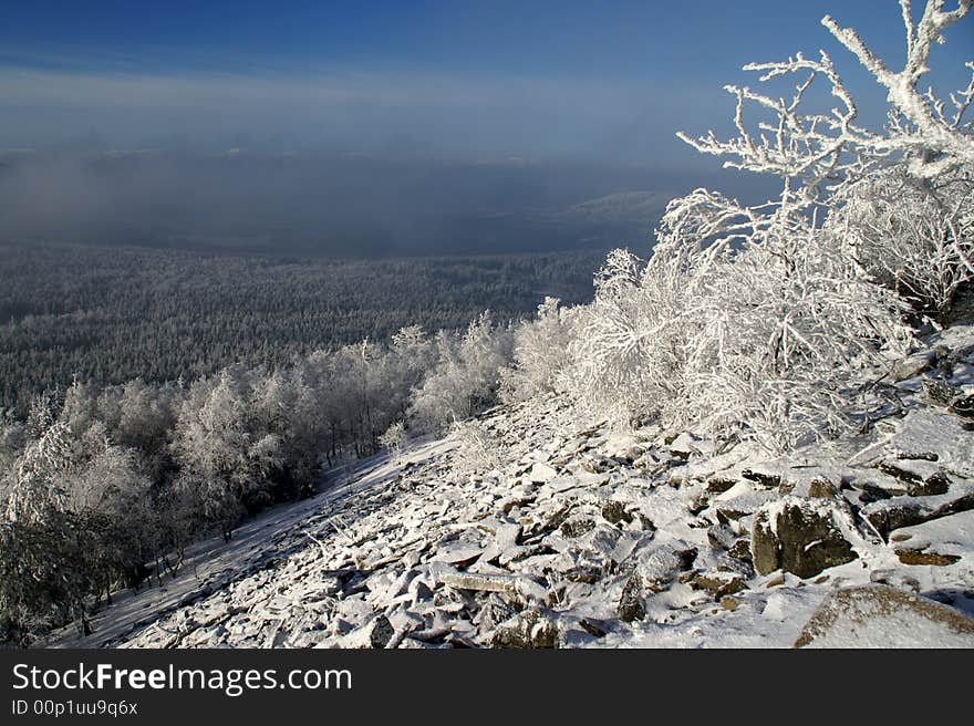 View of snow covered valley with stone field in foreground. View of snow covered valley with stone field in foreground.