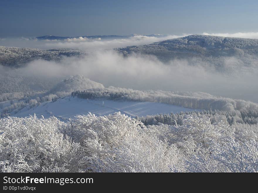 Winter inversion and low lying clouds in snow covered hilly country. Winter inversion and low lying clouds in snow covered hilly country.