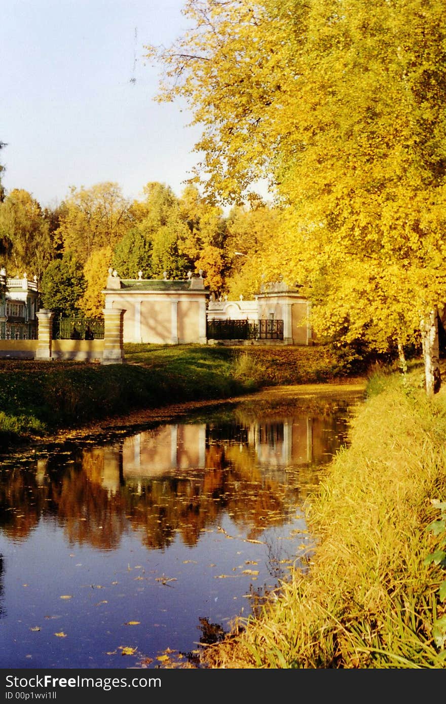 Yellow color of foliage water and small construction in the distance. Yellow color of foliage water and small construction in the distance