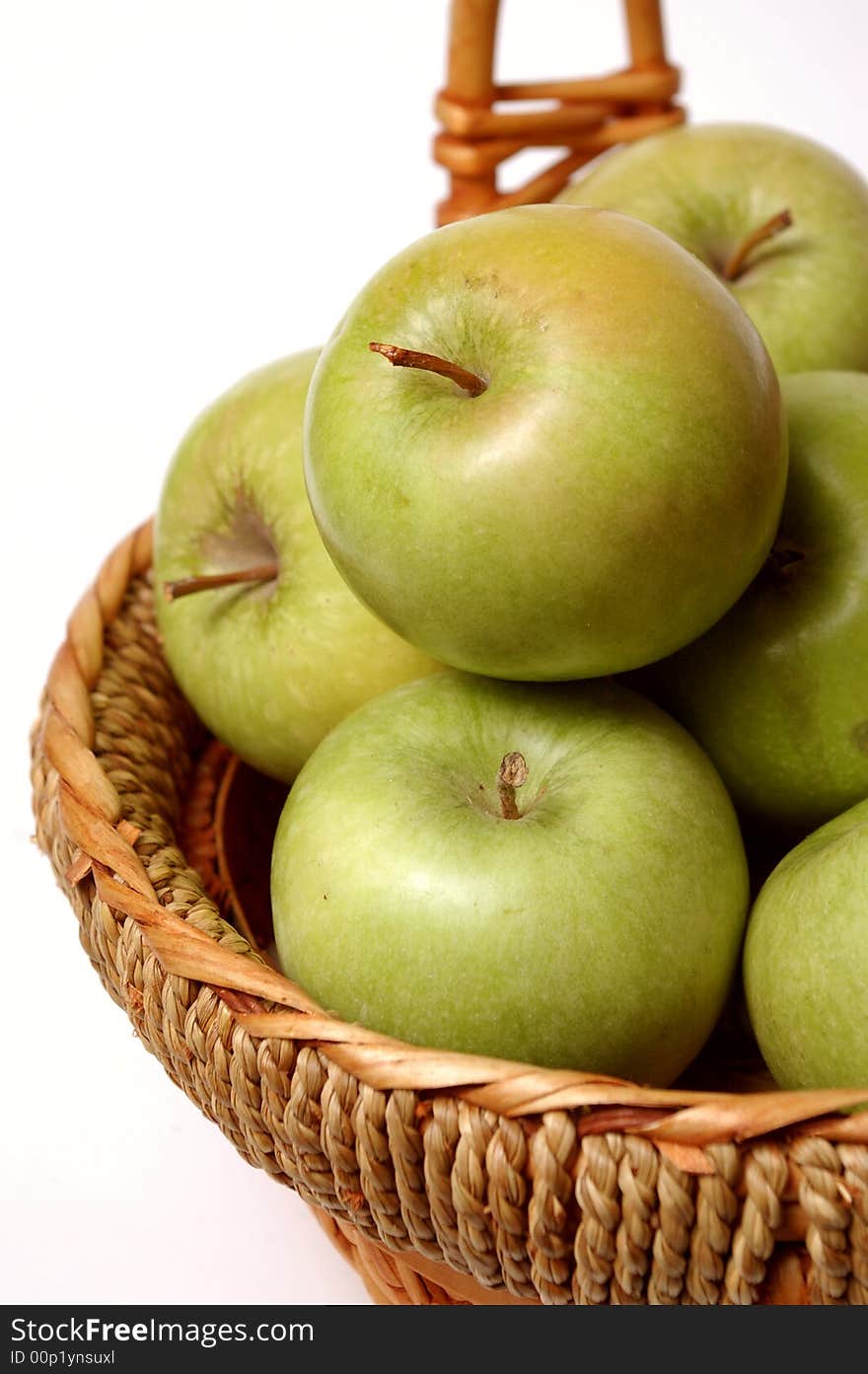 Basket with apples on a bel a background