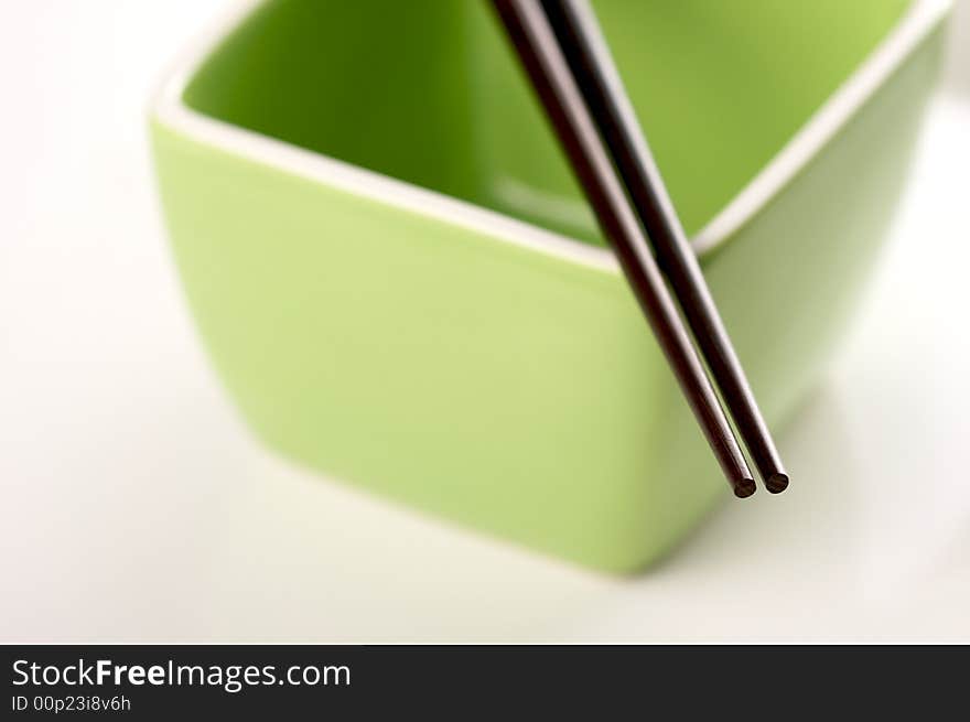 Chopsticks & Green Bowl on a white background.