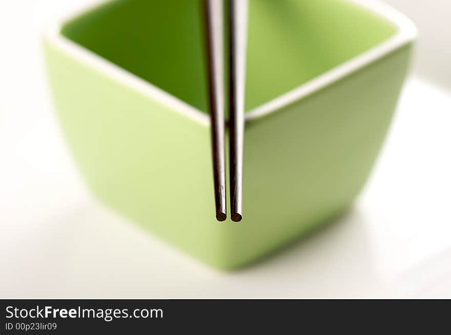 Chopsticks & Green Bowl on a white background.