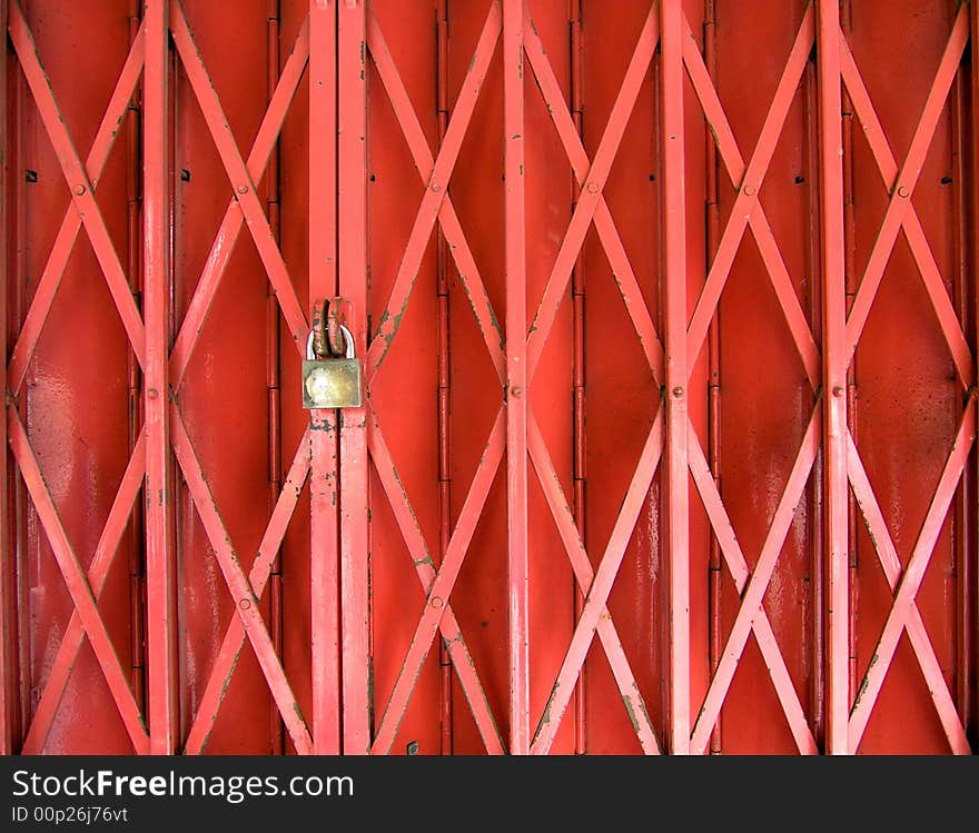 A collapsible gate locked before a collapsible panel door. A collapsible gate locked before a collapsible panel door