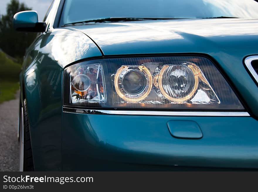 Headlights on a car in the evening