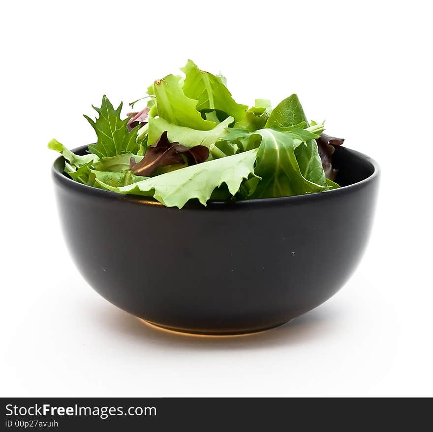 A closeup of a bowl of salad greens.