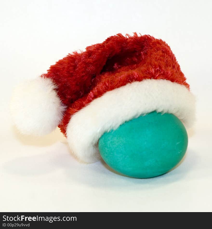 Green-blue egg with red Santa hat. Green-blue egg with red Santa hat.