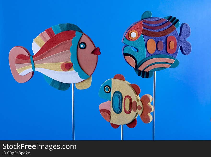 Three family fishes on blue background