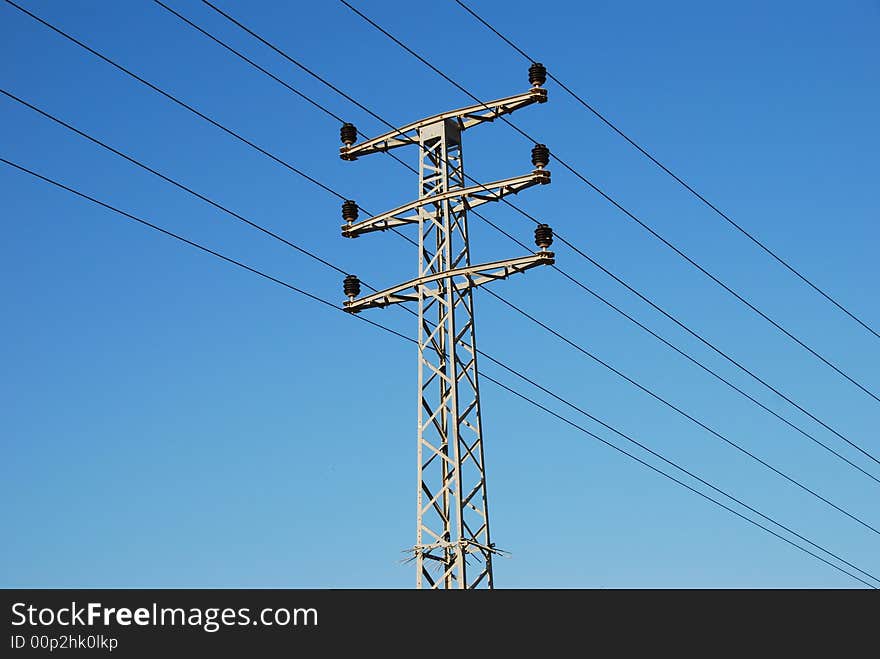 Electrical tower on a background of the blue sky. Electrical tower on a background of the blue sky