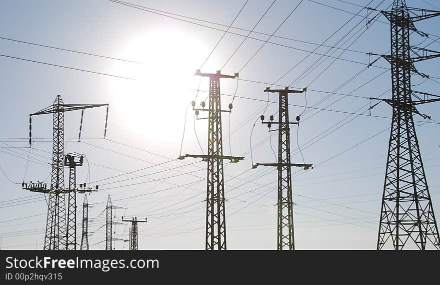 Electrical tower on a background of the blue sky. Electrical tower on a background of the blue sky