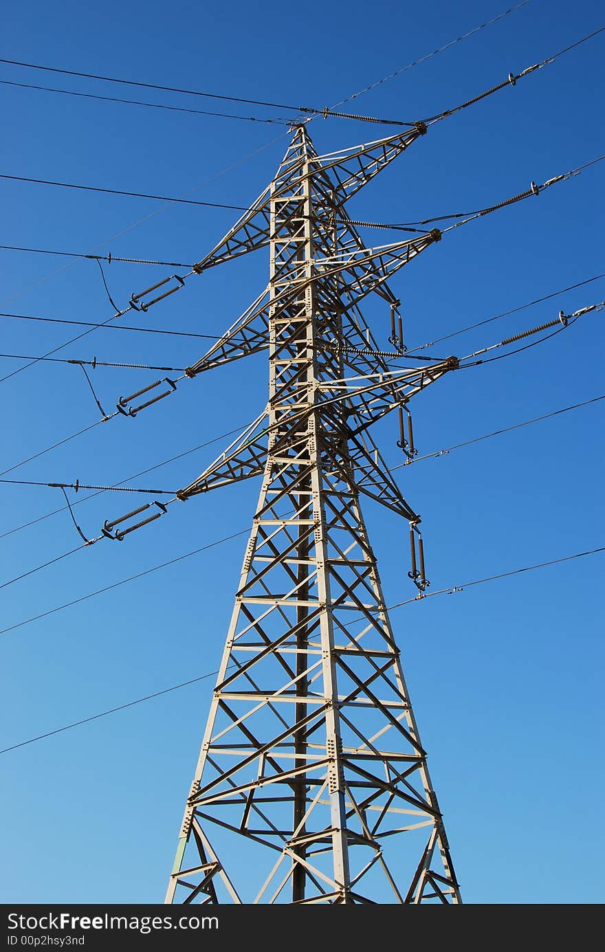 Electrical tower on a background of the blue sky. Electrical tower on a background of the blue sky